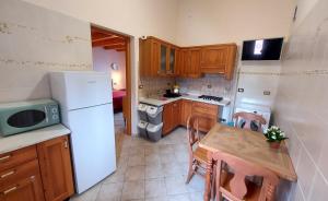 a small kitchen with a table and a refrigerator at Emerald House in Augusta in Augusta