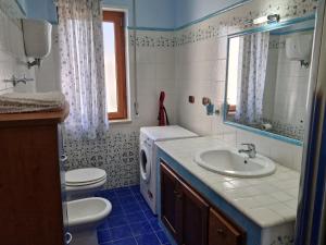 a bathroom with a sink and a washing machine at Casa Alexandr Piedigrotta in Pizzo +27 photos