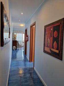 a hallway with a painting hanging on a wall at Casa Alexandr Piedigrotta in Pizzo