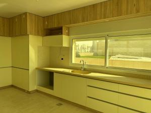 a kitchen with a sink and a window at Villa K تلة الصنوبر in Ḩāşbayyā