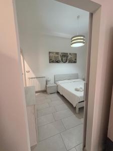 a bedroom with a bed and a pendant light at Il gingillo di Alice by Maniel Beach Hotel in Letojanni +4 photos