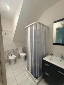 a bathroom with a shower and a toilet and a sink at Il gingillo di Alice by Maniel Beach Hotel in Letojanni