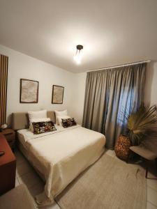 a bedroom with a bed and a potted plant at Paphos-Limnaria Garden in Paphos +49 photos