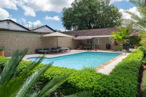 a swimming pool in a yard with plants at Domiya Estate Ltd in Dodoma