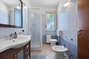 a bathroom with a sink and a toilet at Casa Onda Azzurra in Balestrate