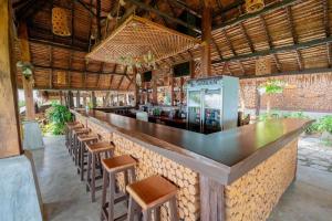 a bar in a restaurant with wooden stools at Phi Phi Phu Chalet Resort in Phi Phi Islands