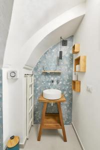 a bathroom with a sink on a table at Dimore di Matilde - Romantic Suite in Gallipoli +17 photos