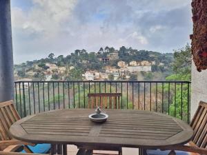 a wooden table on a balcony with a view at Villa Eucaliptus Lloret de Mar in Vidreres