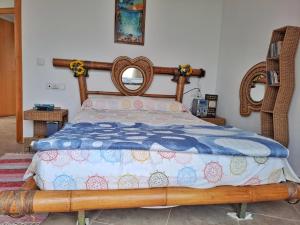 a bedroom with a bed with a wooden frame at Villa Eucaliptus Lloret de Mar in Vidreres
