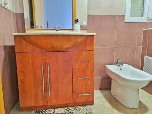 a bathroom with a sink and a toilet at Villa Eucaliptus Lloret de Mar in Vidreres +18 photos