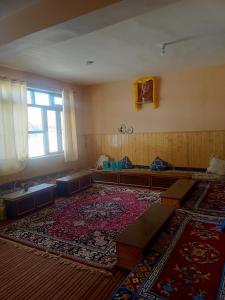 a room with a large rug and a large window at The Dupchen Cave View in Kaja
