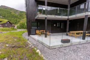 an external view of a building with a table and chairs at Mountain View Apartment 201 in Stranda