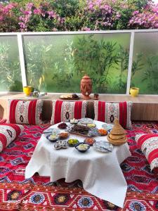 a table with plates of food on top of it at Agadir Best Apparts in Agadir nʼ Aït Sa