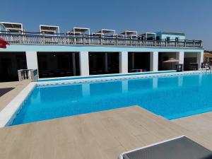 a large swimming pool in front of a building at Hotel Mio City in Kula