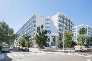 a large white building with a palm tree in front of it at Inter 2 in Salou