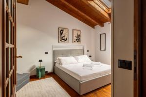 a bedroom with a white bed in a room at Lodge Fiera Milano in Rho