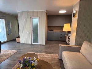 a living room with a couch and a table at Apartamentai Kelmėje in Kelmė