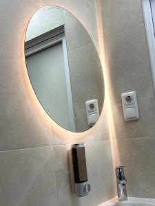 a bathroom with a mirror and a sink at Apartamentai Kelmėje in Kelmė +14 photos