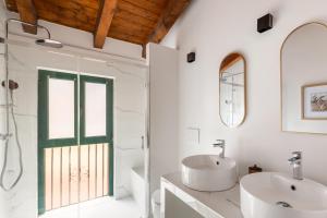 a white bathroom with a sink and a window at Lodge Fiera Milano in Rho +8 photos