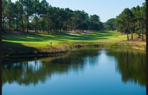 a view of a golf course with a pond at Casa Serra & Mar in Azeitao
