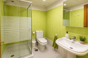 a bathroom with a toilet and a sink and a shower at Velez Nazari Cambriles in Lújar +29 photos