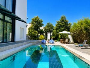 a swimming pool next to a house at Villa Solis Elegant Villa with Private Pool in La Marsa