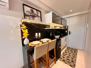 a kitchen with a table and chairs in a room at Flat Manaira Apart Hotel 1605 in João Pessoa