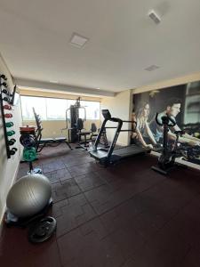 a gym with several people exercising on tread machines at Flat Manaira Apart Hotel 1605 in João Pessoa