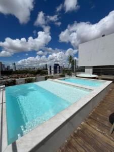 a swimming pool on the roof of a building at Flat Manaira Apart Hotel 1605 in João Pessoa