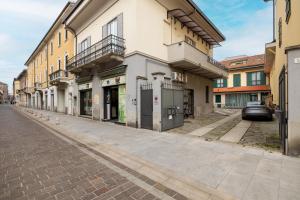 an empty street in a city with buildings at Lodge Fiera Milano in Rho