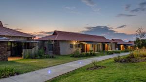 a home with a pathway in front of a yard at The Kingdom Resort in Ledig