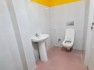 a bathroom with a sink and a toilet at Dooars View Hotel in Hāsimāra