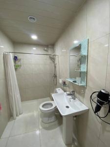 a bathroom with a toilet and a sink and a shower at Мгер Мелконян in Tsaghkadzor