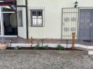 a house with a door and some plants in front of it at Ferienhaus Engel in Fertőhomok