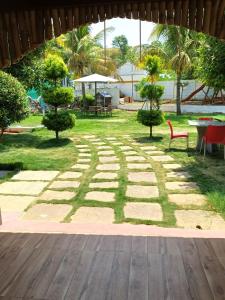 a garden with trees and a stone path at Nenapu Resorts in Oddarahalli