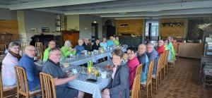 a group of people sitting at tables in a room at Grand Hotel de la Vallée in Cheylade