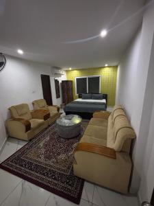 a living room with two couches and a couch at SLV Royal Residency Hotel in Bidadi