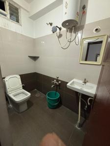 a bathroom with a toilet and a sink at SLV Royal Residency Hotel in Bidadi