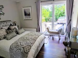 a bedroom with a bed and a sliding glass door at Herlihy's in Farranfore