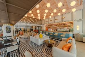 a lobby of a hotel with couches and a bar at A-ONE Bangkok Hotel in Bangkok