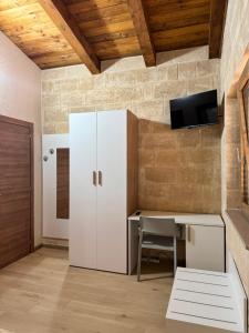 a room with a white cabinet and a desk at Agriturismo Tenuta Santarcangelo in Scanzano
