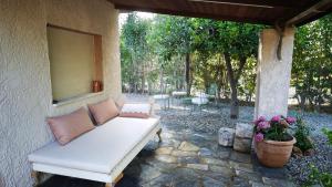 a white couch sitting on a stone patio at LavenderFarmhouse 2 in Nafpaktos
