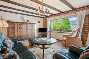 a living room with a couch and a table at Ferienwohnung Rihm in Arrach