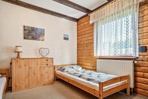 a bedroom with a bed and a window at Ferienwohnung Rihm in Arrach