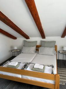 a large bed in a room with wooden ceilings at Moon Light-free parking in Rijeka