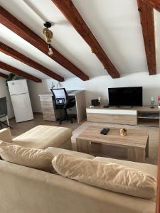a living room with a couch and a flat screen tv at Moon Light-free parking in Rijeka
