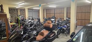 a bunch of motorcycles parked in a garage at Grand Hotel de la Vallée in Cheylade