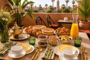 a table with breakfast foods and drinks on it at Riad Sesame in Marrakesh