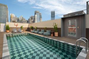 a swimming pool on the roof of a building at lyf Chinatown Singapore in Singapore