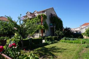 a house with a garden in front of it at Vodice Center Apartments in Vodice